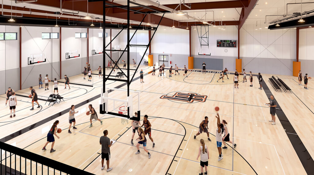Interior view of Legacy Hoops showing multiple basketball courts, shooting lanes, hardwood floors, scoreboards, and players using the facility.