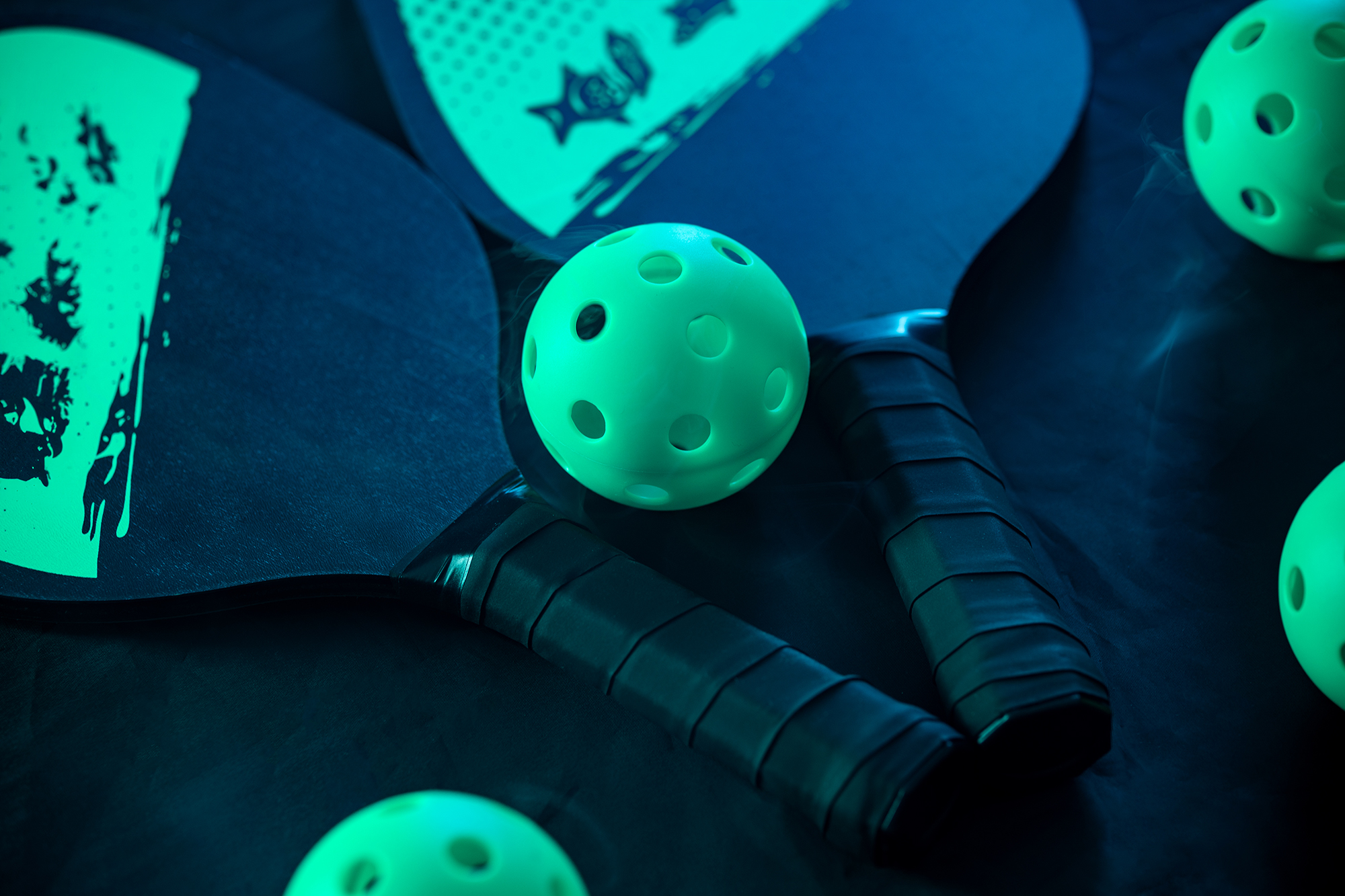 Pickleball game set. Rackets and balls on the court. Copy space. Sports background